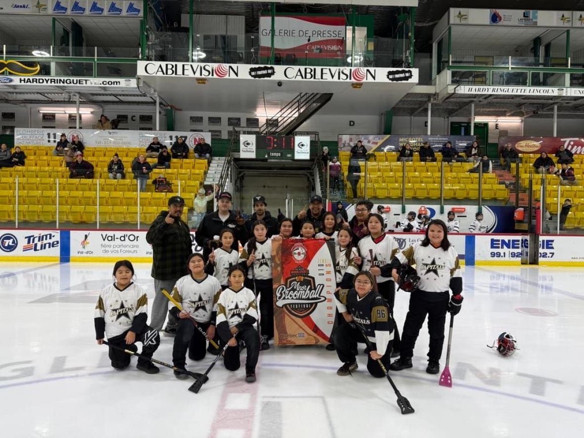 A group of girls on the ice rink.