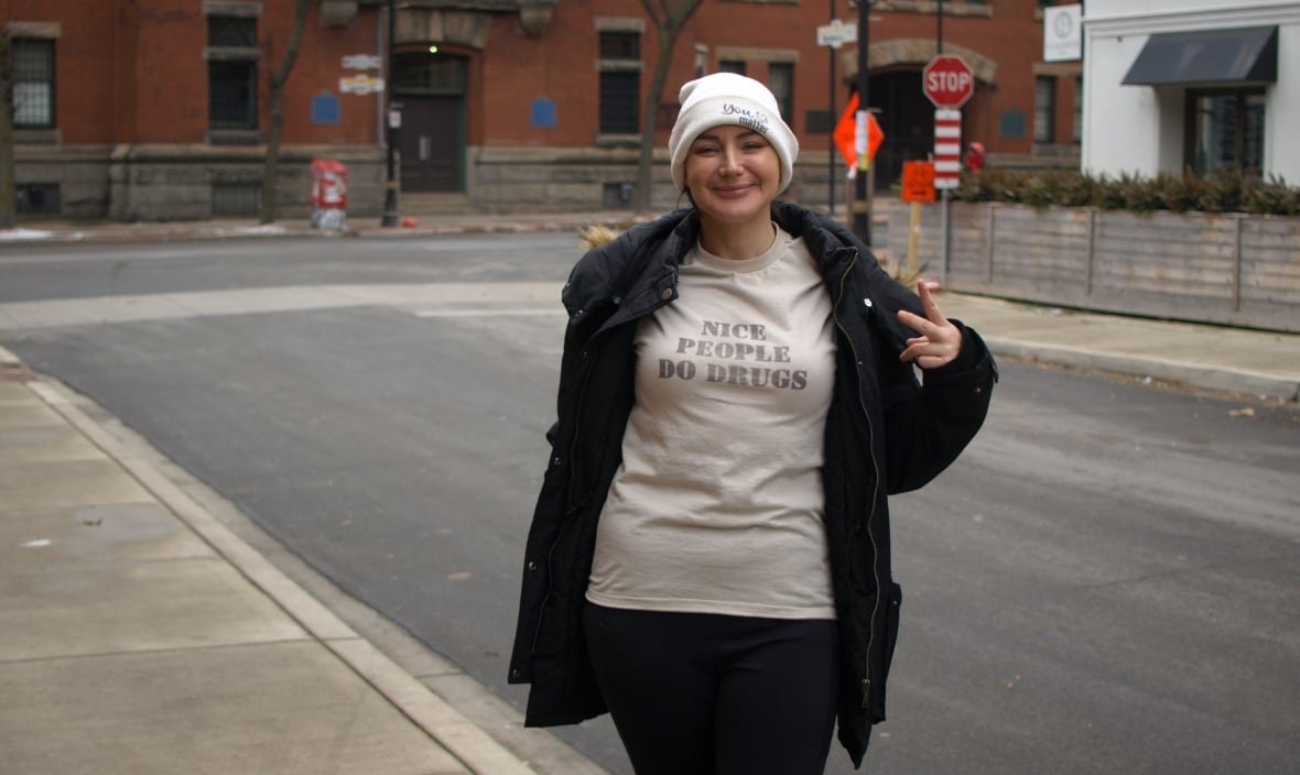 kim-ritchie a person smiles and wears a shirt that says 'nice people do drugs'