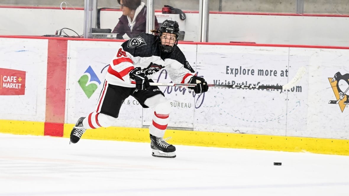 nela-lopu-anova-bishop-kearney-selects2 A hockey player skates along the boards.