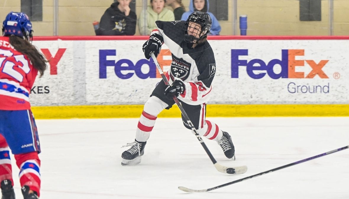 nela-lopusanova-bishop-kearney-selects1 A hockey player takes a shot on the ice.