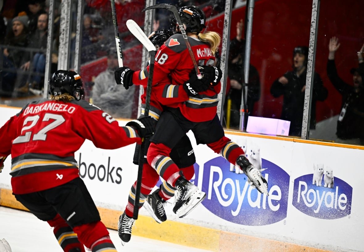 ottawa-charge-2024 Two hockey players jump into each other's arms to celebrate a goal.