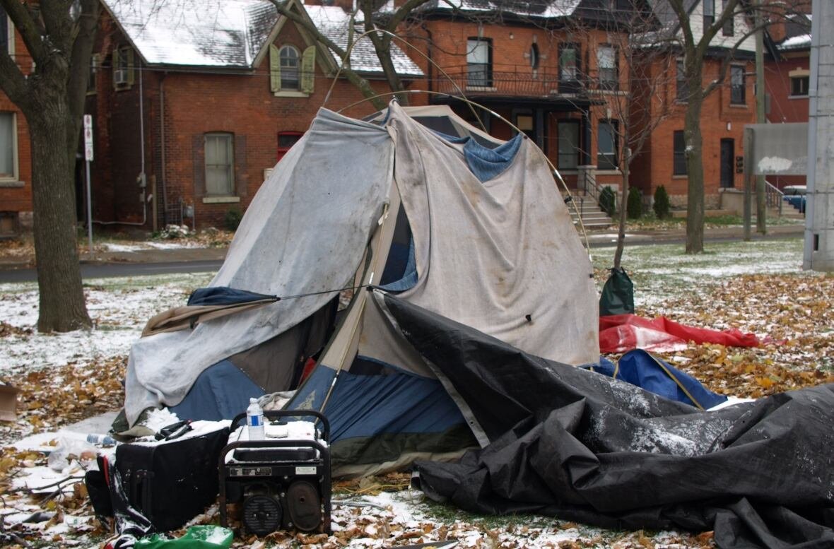 tent-falling-down A tent is falling apart. There is snow on the ground.