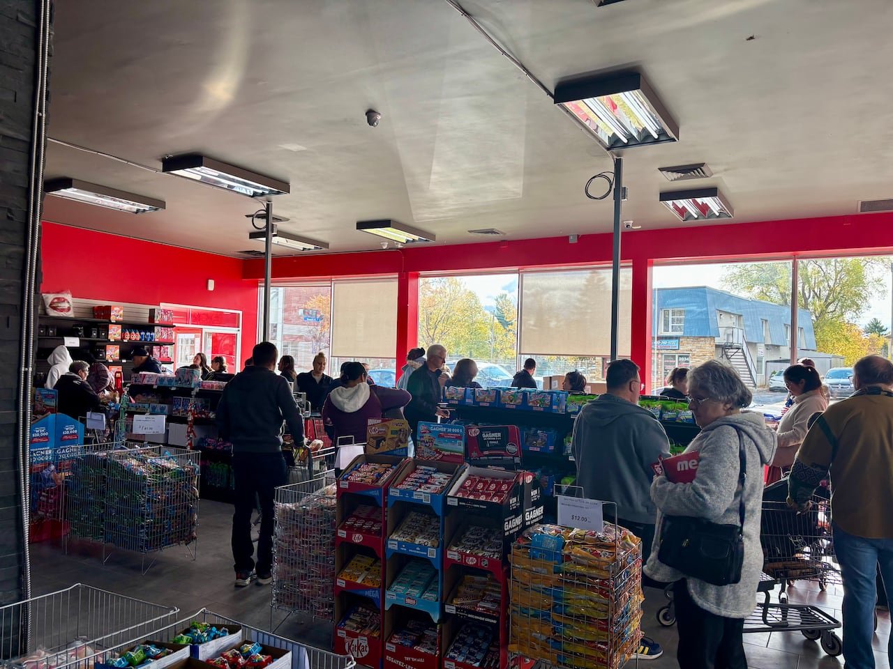 default-362 Shoppers wait in line inside Liquidation Marie grocery store in Longueuil, Quebec. The store is gaining in popularity among other discount grocery chains amid rising food prices across Canada.