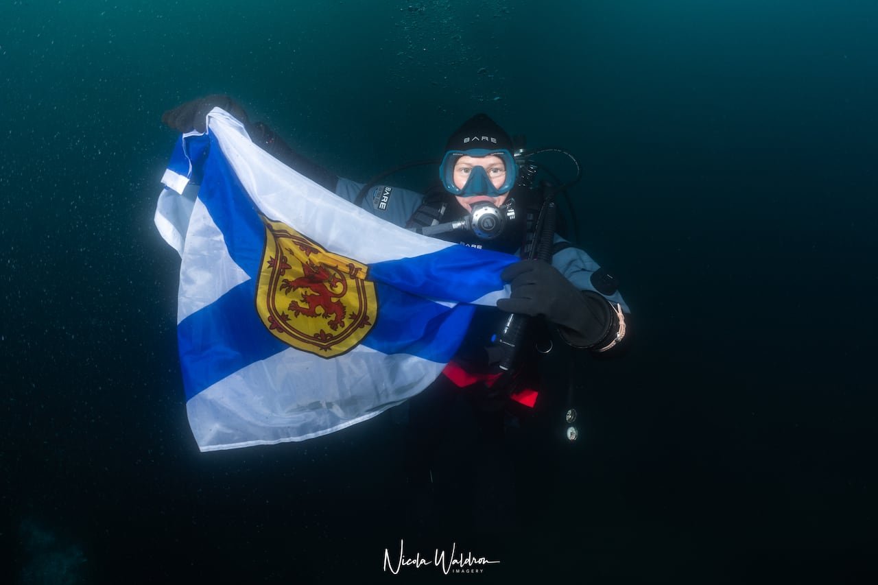 default-373 A woman holds a flag under the water.