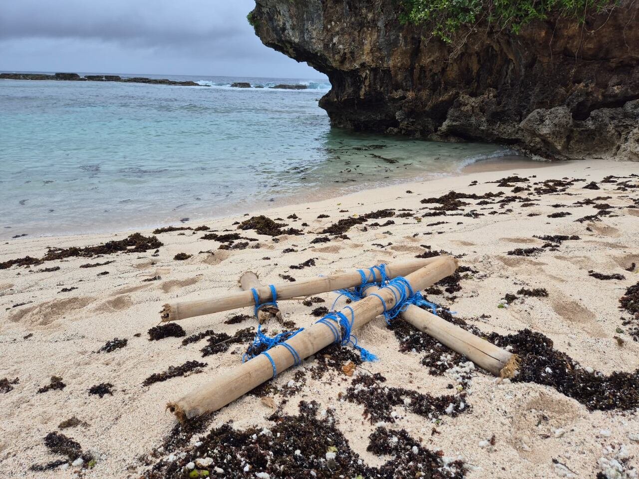 Logs tied with polyester rope on a beach